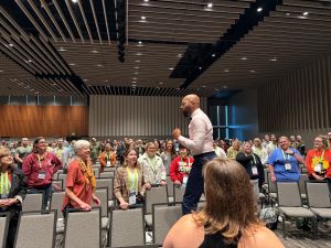 Dr. Christopher Emdin energizes the audience, walking through the crowd during his keynote. 