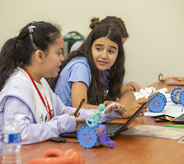 3.	A high school team collaborating during a coding lesson.