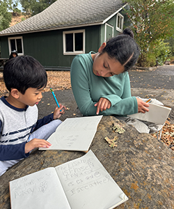 Students nature journaling with their buddies. 