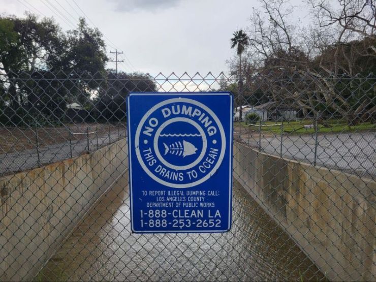 Figure 1. The Verdugo Wash, a cemented tributary of the Los Angeles River passing through Glendale, CA, with signs discouraging the dumping of trash and pollutants in the river